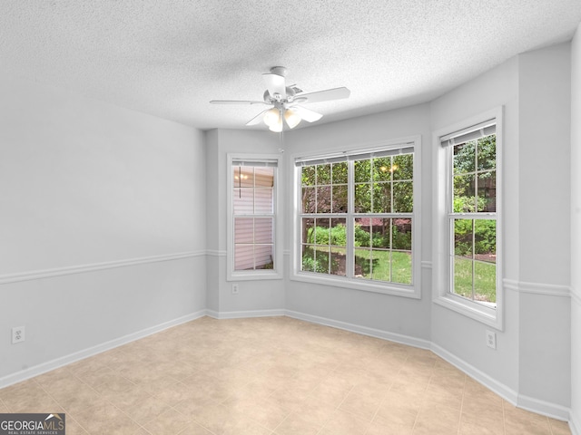 264 Keller Dr, Mcdonough, GA 30252 - unfurnished room with a ceiling fan, healthy amount of natural light, a textured ceiling, and baseboards