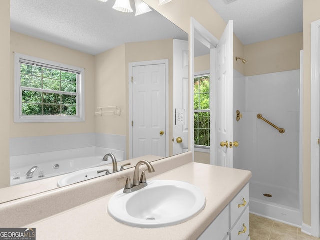 264 Keller Dr, Mcdonough, GA 30252 - full bathroom with vanity, tile patterned floors, a stall shower, a textured ceiling, and a whirlpool tub