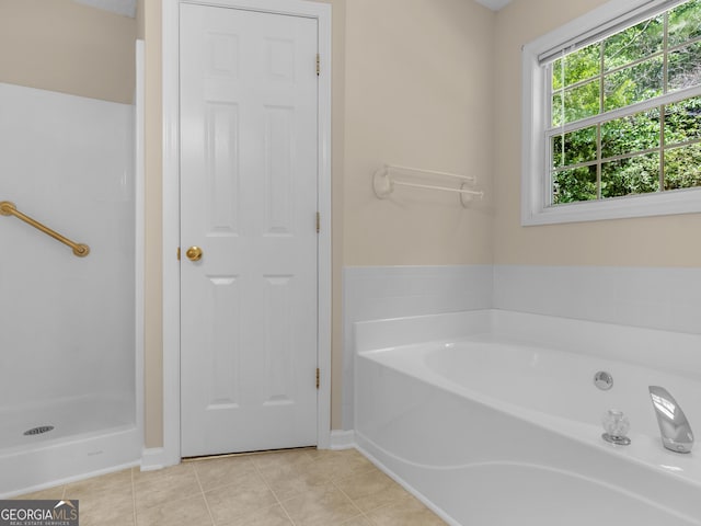 264 Keller Dr, Mcdonough, GA 30252 - full bath featuring a garden tub, tile patterned flooring, and baseboards