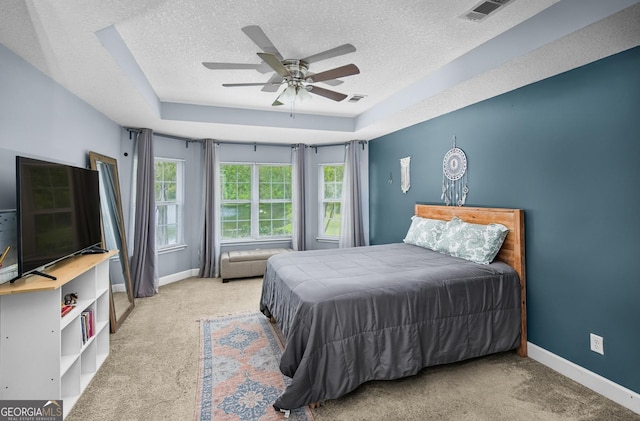 326 Daniel Trent Way, Kingsland, GA 31548 - carpeted bedroom with a textured ceiling, a raised ceiling, baseboards, and ceiling fan