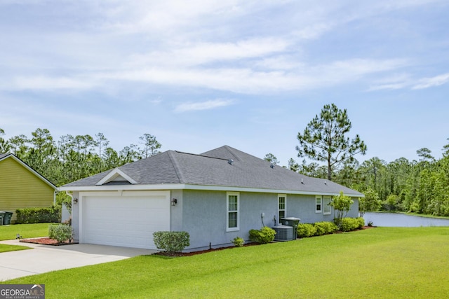 326 Daniel Trent Way, Kingsland, GA 31548 - view of home's exterior with stucco siding, concrete driveway, a garage, a yard, and central air condition unit