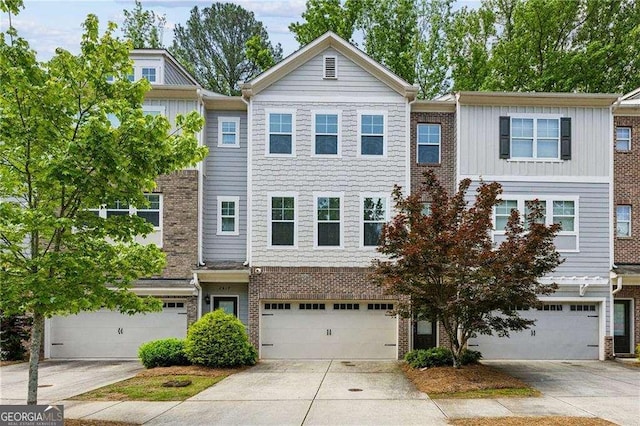 2817 White Oak Ln, Decatur, GA 30032 - multi unit property with an attached garage, concrete driveway, brick siding, and board and batten siding