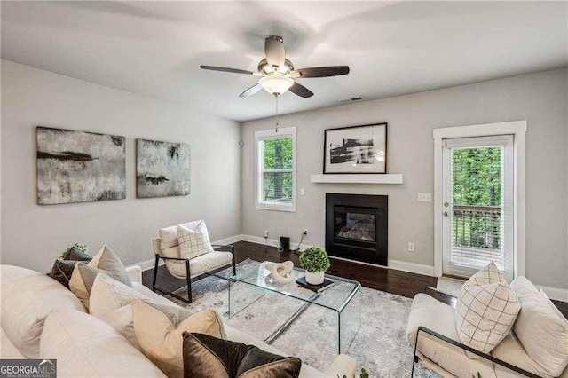 2817 White Oak Ln, Decatur, GA 30032 - living room with a glass covered fireplace, baseboards, a ceiling fan, and wood finished floors