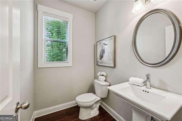 2817 White Oak Ln, Decatur, GA 30032 - half bathroom featuring toilet, wood finished floors, and baseboards