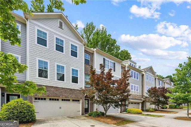 2817 White Oak Ln, Decatur, GA 30032 - townhome / multi-family property featuring a garage, concrete driveway, and brick siding