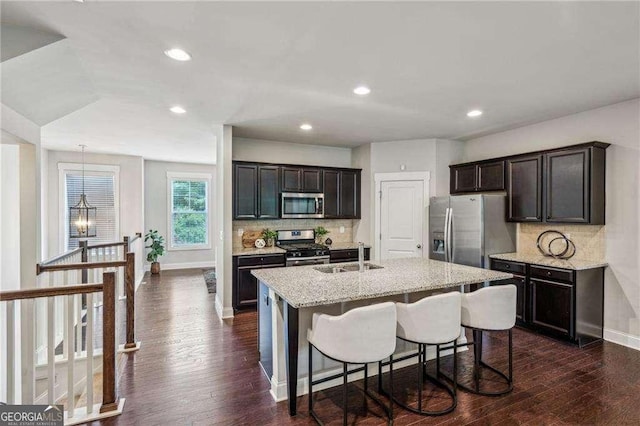 2817 White Oak Ln, Decatur, GA 30032 - kitchen with appliances with stainless steel finishes, a sink, baseboards, decorative backsplash, and a center island with sink
