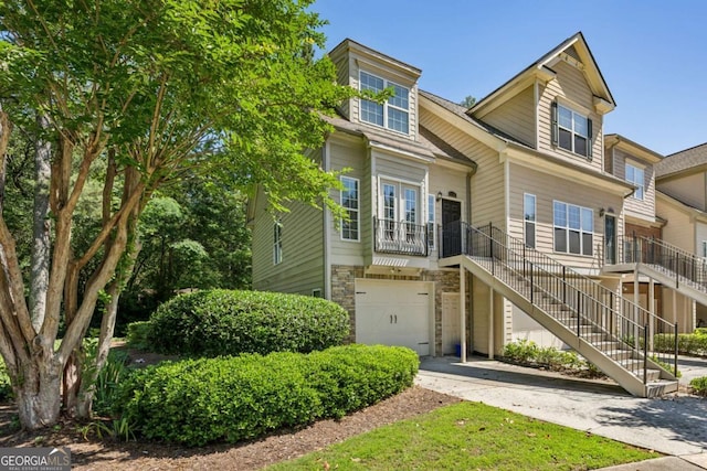 3150 Stonewyck Pl, Decatur, GA 30033 - view of property with an attached garage, stairs, driveway, and stone siding
