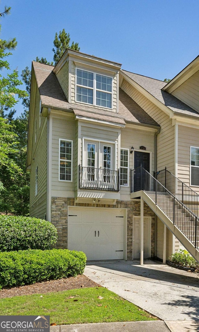 3150 Stonewyck Pl, Decatur, GA 30033 - view of front of home with a garage, stone siding, concrete driveway, stairway, and a shingled roof