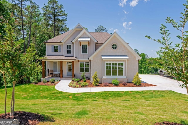 1013 Liberty Springs Dr, Woodstock, GA 30188 - craftsman house featuring board and batten siding, covered porch, brick siding, and a front lawn