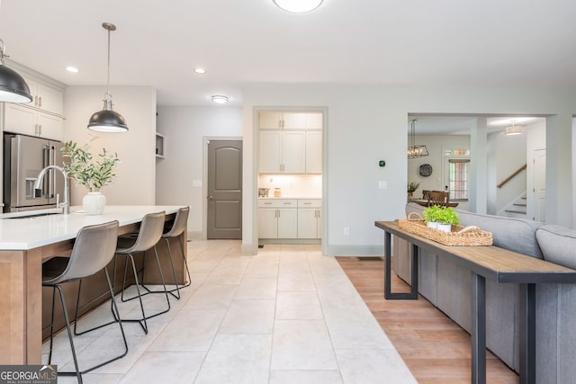 1013 Liberty Springs Dr, Woodstock, GA 30188 - kitchen featuring high end refrigerator, light countertops, recessed lighting, pendant lighting, and a breakfast bar