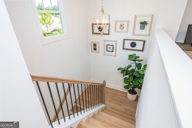 1013 Liberty Springs Dr, Woodstock, GA 30188 - staircase featuring wood finished floors and a chandelier