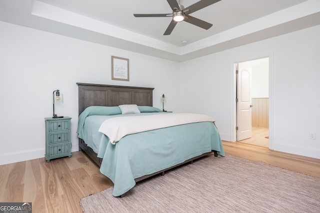 1013 Liberty Springs Dr, Woodstock, GA 30188 - bedroom with a raised ceiling, light wood-style flooring, and ceiling fan