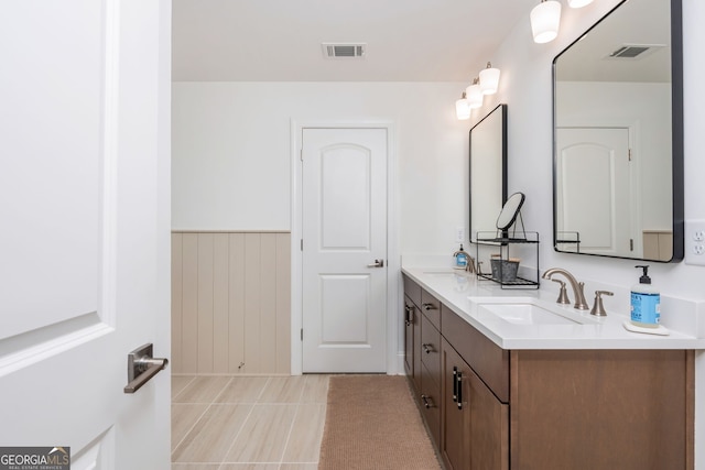 1013 Liberty Springs Dr, Woodstock, GA 30188 - full bath with double vanity, tile patterned flooring, and a wainscoted wall