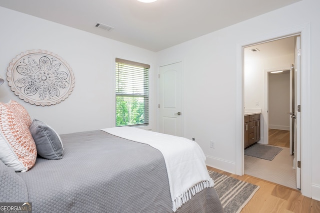 1013 Liberty Springs Dr, Woodstock, GA 30188 - bedroom with light wood-type flooring and ensuite bathroom