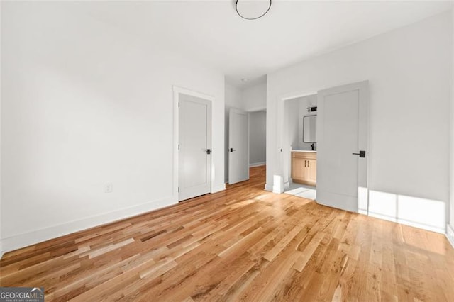 327 Ohm, Avondale Estates, GA 30002 - unfurnished bedroom with light wood-style floors, baseboards, and connected bathroom