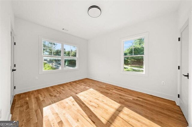 327 Ohm, Avondale Estates, GA 30002 - spare room featuring wood finished floors and baseboards