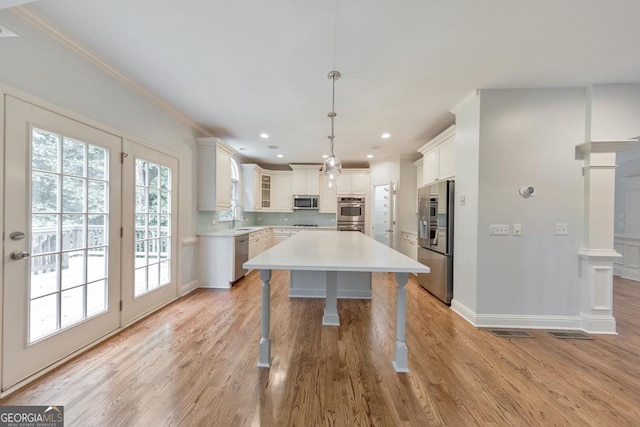 1575 Petal Pt NW, Kennesaw, GA 30152 - kitchen with stainless steel appliances, a sink, healthy amount of natural light, light countertops, and crown molding