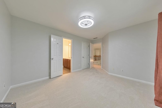 1575 Petal Pt NW, Kennesaw, GA 30152 - unfurnished bedroom featuring light colored carpet, baseboards, and ensuite bathroom