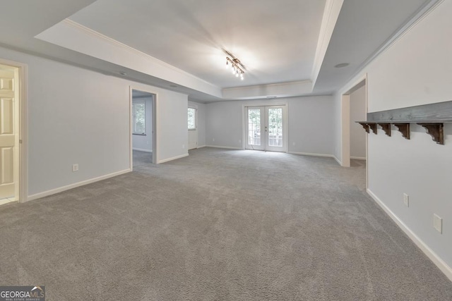 1575 Petal Pt NW, Kennesaw, GA 30152 - unfurnished living room with a raised ceiling, carpet, ornamental molding, track lighting, and baseboards