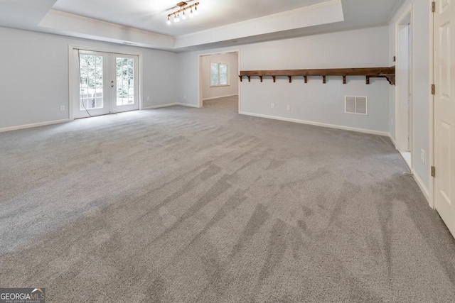 1575 Petal Pt NW, Kennesaw, GA 30152 - unfurnished living room with a raised ceiling, carpet floors, baseboards, and french doors