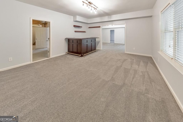 1575 Petal Pt NW, Kennesaw, GA 30152 - unfurnished living room with carpet, baseboards, bar, and track lighting
