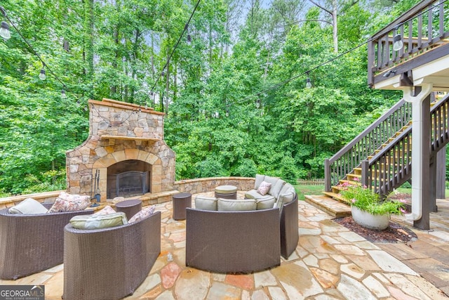 1575 Petal Pt NW, Kennesaw, GA 30152 - view of patio / terrace with stairs, an outdoor living space with a fireplace, and view of wooded area
