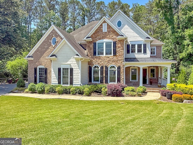 1575 Petal Pt NW, Kennesaw, GA 30152 - view of front of home featuring covered porch, a front lawn, stone siding, and a standing seam roof