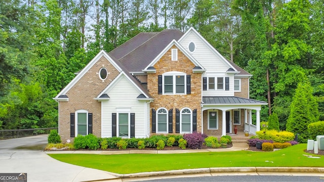 1575 Petal Pt NW, Kennesaw, GA 30152 - view of front of home with covered porch, stone siding, a standing seam roof, brick siding, and a front yard
