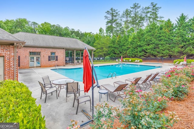 1575 Petal Pt NW, Kennesaw, GA 30152 - community pool featuring a patio and view of wooded area