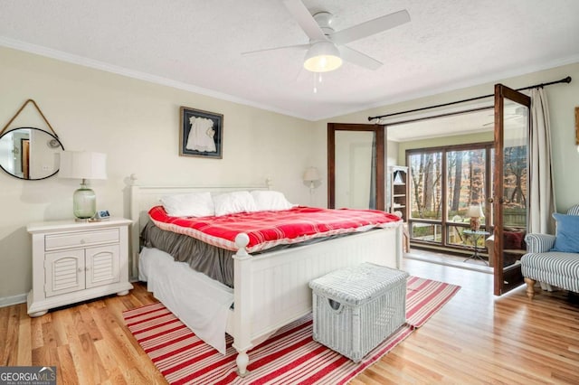 2796 County Line Rd NW, Acworth, GA 30101 - bedroom featuring light wood-style floors, access to exterior, crown molding, a textured ceiling, and ceiling fan