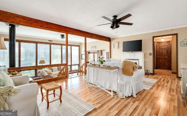 2796 County Line Rd NW, Acworth, GA 30101 - living area featuring ceiling fan, beam ceiling, light wood finished floors, a textured ceiling, and crown molding