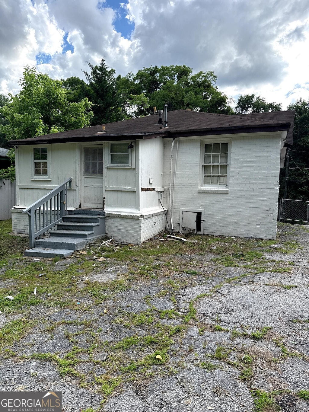 303 Anderson Ave NW, Atlanta, GA 30314 - back of property featuring entry steps, brick siding, crawl space, and central AC