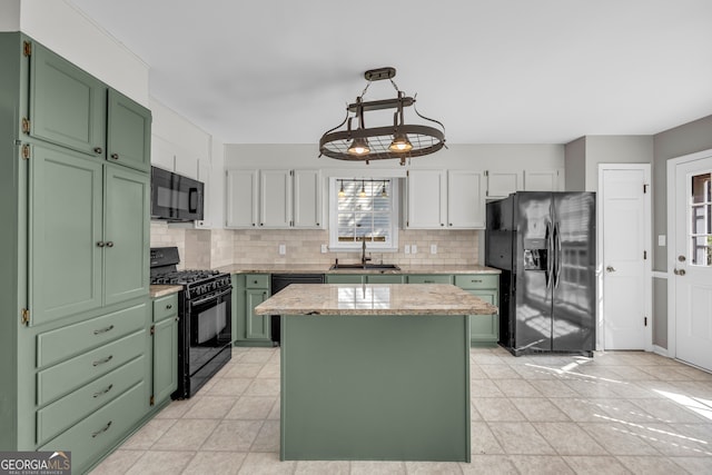 2151 Hamstead Ct, Suwanee, GA 30024 - kitchen with green cabinetry, black appliances, a sink, decorative backsplash, and a center island