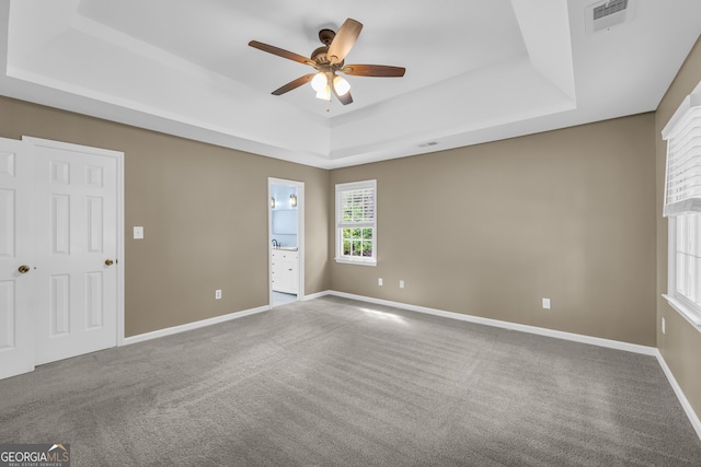 2151 Hamstead Ct, Suwanee, GA 30024 - unfurnished bedroom featuring a tray ceiling, carpet flooring, and baseboards
