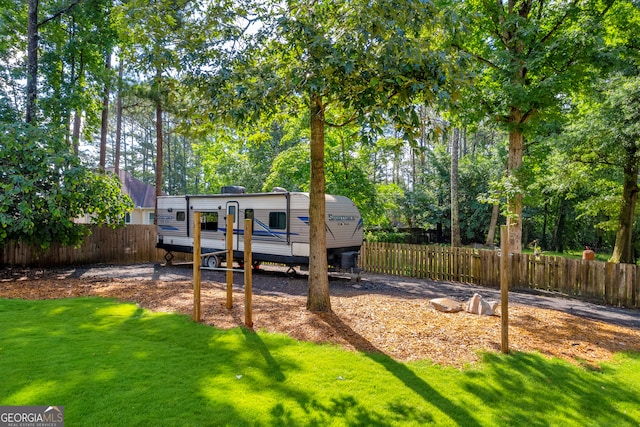 2151 Hamstead Ct, Suwanee, GA 30024 - rear view of house with a wooden deck and view of scattered trees