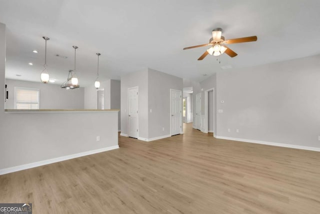 955 Mill Creek Ave, Canton, GA 30115 - unfurnished living room featuring light wood-style floors, ceiling fan, baseboards, and recessed lighting
