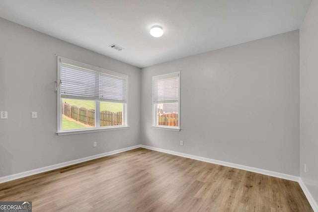 955 Mill Creek Ave, Canton, GA 30115 - empty room featuring wood finished floors, baseboards, and healthy amount of natural light