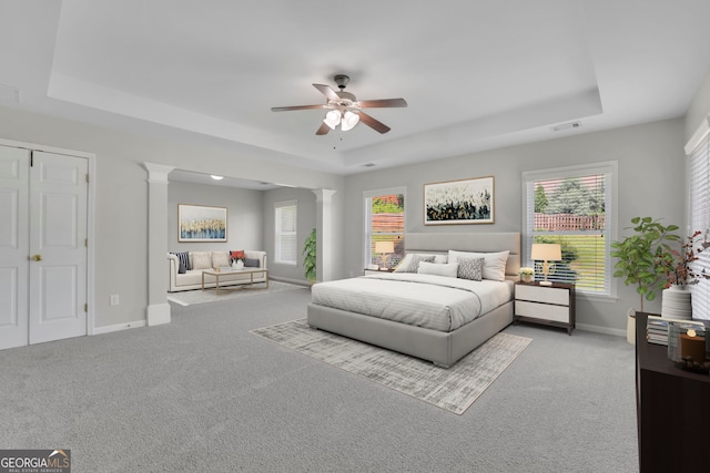 955 Mill Creek Ave, Canton, GA 30115 - carpeted bedroom featuring a tray ceiling, decorative columns, baseboards, and ceiling fan