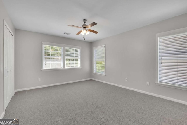 955 Mill Creek Ave, Canton, GA 30115 - unfurnished bedroom with multiple windows, carpet, and baseboards