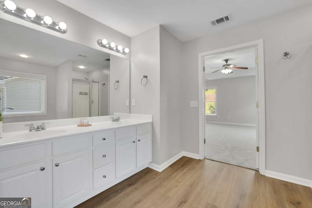 955 Mill Creek Ave, Canton, GA 30115 - bathroom featuring a stall shower, wood finished floors, double vanity, and baseboards