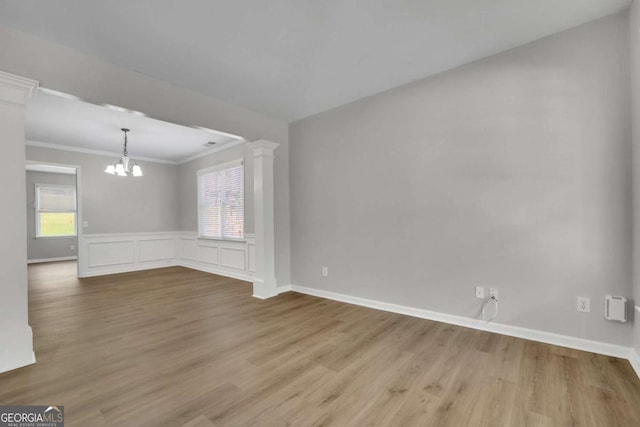 955 Mill Creek Ave, Canton, GA 30115 - spare room with a chandelier, wood finished floors, crown molding, baseboards, and wainscoting