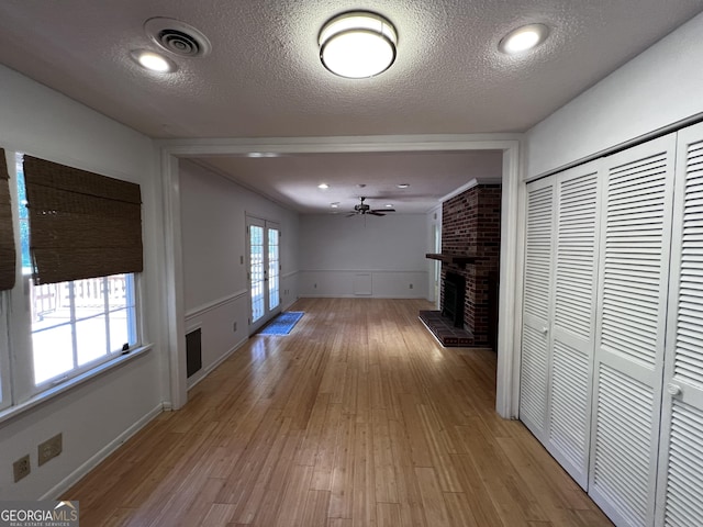 2976 Twin Pine Rd, Thomson, GA 30824 - hall with light wood finished floors, a textured ceiling, and a wainscoted wall