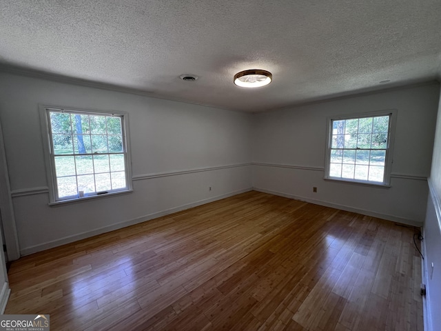 2976 Twin Pine Rd, Thomson, GA 30824 - empty room with wood finished floors, a textured ceiling, and baseboards
