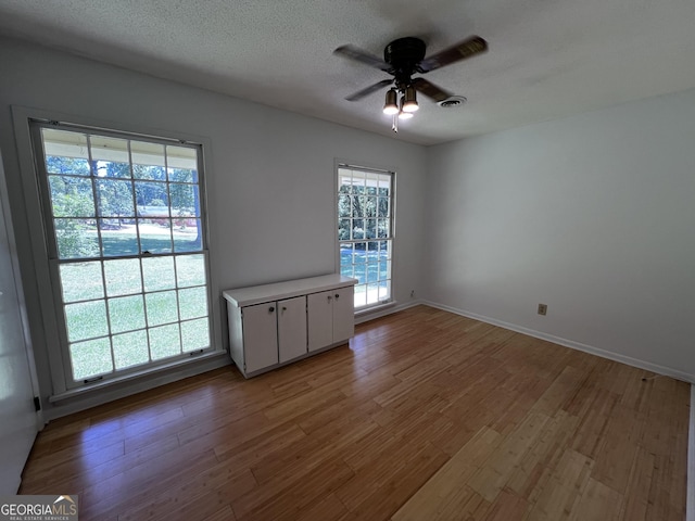 2976 Twin Pine Rd, Thomson, GA 30824 - spare room featuring ceiling fan, wood finished floors, baseboards, and a textured ceiling
