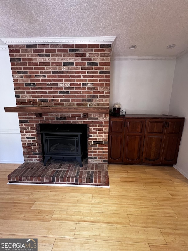 2976 Twin Pine Rd, Thomson, GA 30824 - detailed view of wood finished floors, crown molding, a textured ceiling, and baseboards