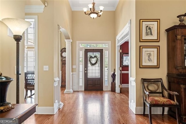 4115 Gold Mill Rdg, Canton, GA 30114 - foyer with ornate columns, wood finished floors, ornamental molding, a chandelier, and baseboards