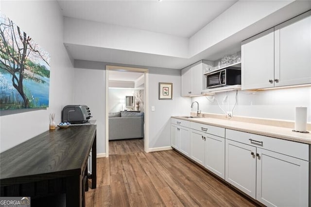4115 Gold Mill Rdg, Canton, GA 30114 - kitchen with stainless steel microwave, a sink, open shelves, white cabinets, and wood finished floors
