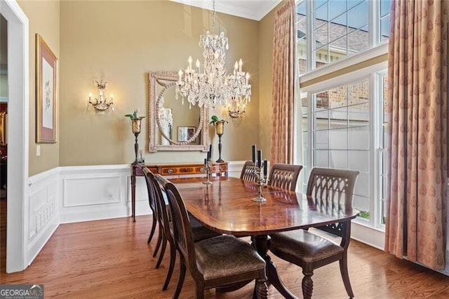 4115 Gold Mill Rdg, Canton, GA 30114 - dining room featuring a chandelier, wood finished floors, a high ceiling, wainscoting, and ornamental molding