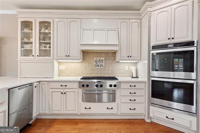 4115 Gold Mill Rdg, Canton, GA 30114 - kitchen featuring stainless steel appliances, a warming drawer, light countertops, glass insert cabinets, and backsplash