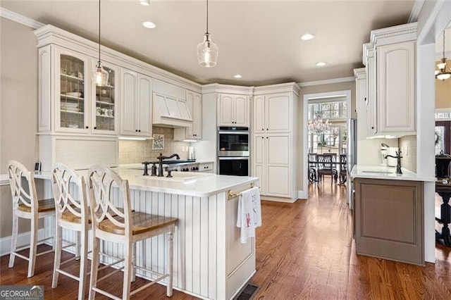 4115 Gold Mill Rdg, Canton, GA 30114 - kitchen featuring double oven, a peninsula, a kitchen breakfast bar, glass insert cabinets, and tasteful backsplash